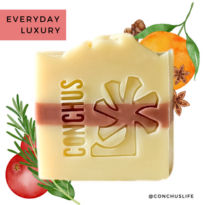 Handmade Christmas soap bar MERRY by CONCHUS on a wooden surface