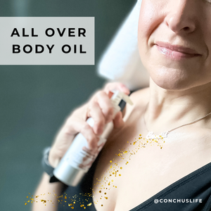 Person applying CONCHUS MERRY Light Oil as an all-over body oil.